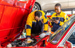 © Rakchanok - Auto repair shop, small business owner, garage, technology, couple diagnose car with laptop, diverse mechanic team collaboration, service communication, customer support, digital automotive workshop