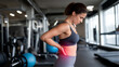 © Alexander - Fit young woman in sportswear holding her lower back in gym, close-up fitness injury concept, workout pain, muscle strain, health awareness, exercise safety and active lifestyle theme