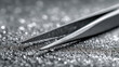 © Mikhail Vorobev - Precision metal tweezers tool gripping a tiny shiny diamond against a sparkling textured surface with selective focus and silver highlights in close-up photography