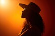 © Andrii Zastrozhnov - Silhouette of african female in hat against orange light
