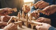 © MdAsiful - Hands building a wooden bridge model together