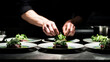 © Bonsales - Chef plating gourmet dinner dishes in a professional kitchen, hands arranging fresh greens on multiple plates
