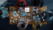 © InfiniteFlow - Overhead view of diverse individuals collaborating on an artificial intelligence project in a modern workspace, showcasing innovation and teamwork dynamics through technology. Trope