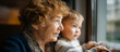 © Kateryna - Faceless grandmother and young faceless grandson looking out of window together intergenerational bonding shared moment watching outside world family connection patient