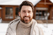 © Maria Vitkovska - Happy man smiling outdoor in winter, wearing warm clothing in snowy environment