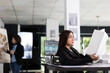 © DC Studio - Professional female architect reviews building prototype, cross checking client measurement requirements. Asian woman with 3d model in hand, working on blueprint designs at modern office desk