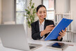 © David - Female call center operator doing her job with a headset.Portrait of call center holds a clipboard worker at office.