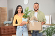© Pixel-Shot - Young couple with belongings in rented apartment on moving day