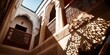 © kwanchaift - A brightly lit courtyard of a traditional Riad in Morocco, focus on geometric shadows and vibrant architectural details, high key daylight.