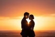 © Meow Creations - Silhouette of a romantic couple embracing and looking at each other during a beautiful sunset