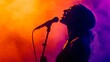© olga_demina - Silhouette of a female singer passionately singing into a microphone on a stage illuminated with vibrant orange and purple lights, creating a dramatic and artistic performance atmosphere
