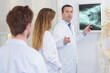 © auremar - Doctor with colleagues pointing to xray