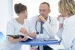 © auremar - group of doctors looking at a clipboard