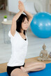 © auremar - asian woman doing yoga exercises at home