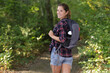 © auremar - tourist with backpack on her back looks back in nature