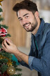 © auremar - portrait of man preparing a christmas tree
