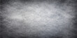 © nur - A dark aged grunge metal texture with a brushed gray concrete pattern creates a dirty vintage surface on this rough black industrial wall backdrop