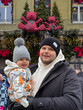 © phpetrunina14 - Father holding baby at festive christmas market Portrait
