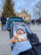 © phpetrunina14 - Baby in stroller at festive city square with christmas tree Copy Space