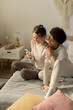 © Bliss - Two loving women share a joyful moment while relaxing in their cozy bedroom together