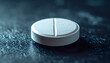 © hardvicore - White pill with dividing line on dark surface, healthcare and pain relief concept.