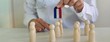 © Nadzeya - Medical professional demonstrating magnetism principles with wooden figures
