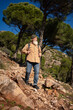 © sutulastock - Senior man hiking on rocky mountain trail in forest landscape, active elderly lifestyle, outdoor adventure, healthy aging, freedom, travel, endurance, nature exploration
