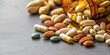 © plysuikvv - Mixed nuts and dietary supplements spill over a table Generative AI
