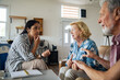 © Marko Geber - Social worker consulting with elderly couple at home