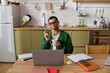 © LIGHTFIELD STUDIOS - Handsome young man enjoying a cozy moment at home while working with his laptop