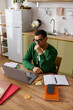 © LIGHTFIELD STUDIOS - Young man reflects thoughtfully in a cozy home workspace filled with vibrant colors and inspiration