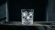 © Daria Horokhova - Dramatic Glass of Pure Water with Ice Cubes Still Life. Side-lit crystal glass filled with pristine water and ice against dark moody background, dramatic shadows and highlights, artistic composition