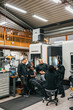 © Maskot - Team of factory professionals discussing with each other in factory
