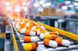 © vectorizer88 - Orange and White Capsules on Production Line in Drug Manufacturing Facility