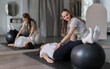 © Mindaugas Dulinskas - Physiotherapist Assisting Pregnant Woman With Exercise Ball Pilates Rehab Session In Modern Therapy Studio