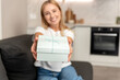 © brizmaker - Happy woman presents a wrapped gift box