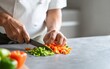 © indah - Chef Chopping Fresh Vegetables on Kitchen Counter