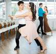 © JackF - Young man and young woman dance pair tango dance in studio