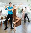 © JackF - Couple of young guy and young woman dancing latin dances in studio