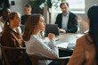 © Maskot - Team of corporate professionals attending group meeting at office