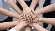 © Studicon - Group of diverse people stacking hands in a show of unity