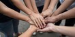 © Studicon - Diverse group of people put hands together in center symbolizing unity