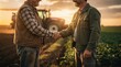 © JT Studio - Two men shake hands in a field at sunset, with a tractor in the background symbolizing farming and cooperation.