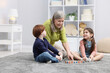 © New Africa - Nanny and cute little kids playing with cubes indoors, space for text