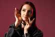 © New Africa - Beautiful young woman with piercings and stylish accessories in red light on pink background