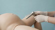 © xuxu - Doctor hand with white glove inserting speculum into female anatomical model. Gynecological examination procedure for medical training concept.