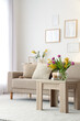 © Pixel-Shot - Interior of light living room with sofa, table and spring flowers