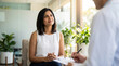 © ViskBx - Young indian woman consulting with a doctor or therapist in a bright office