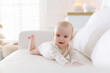 © New Africa - Cute little baby on sofa at home