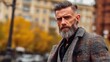 © NovaVision - Mature man with stylish beard and haircut posing outdoors in autumn city setting